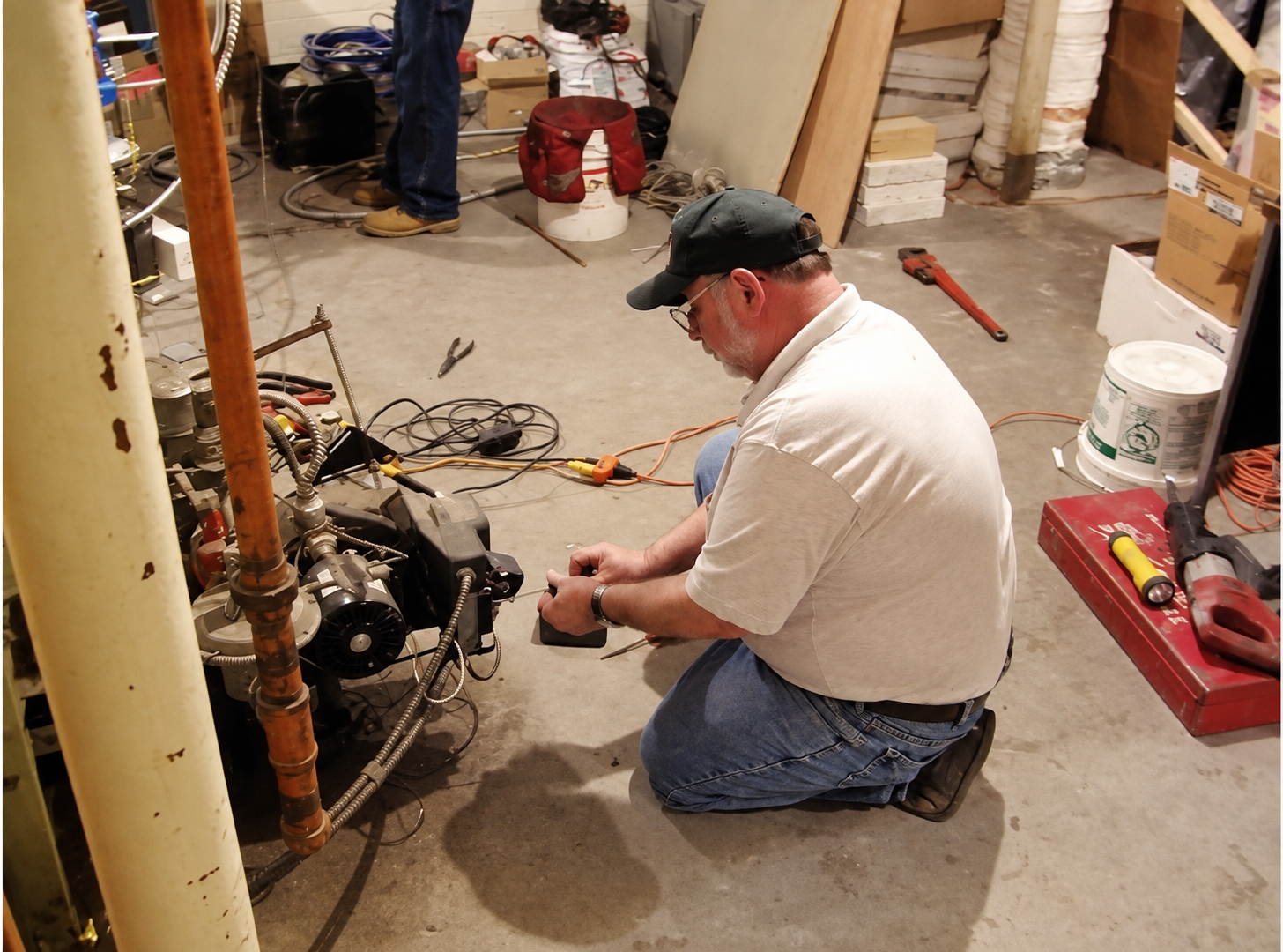 Grant Roberts Sr. working in a mechanical room
